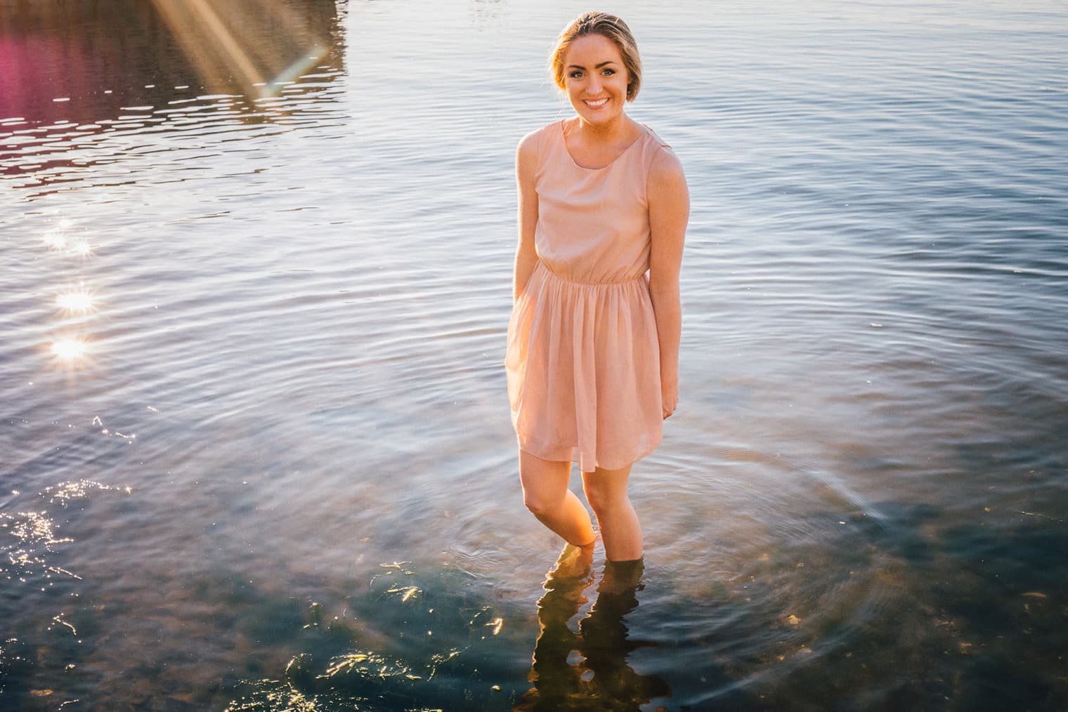 Beloved photo session at the beach in Gothenburg. In the water enjoying the setting sun.